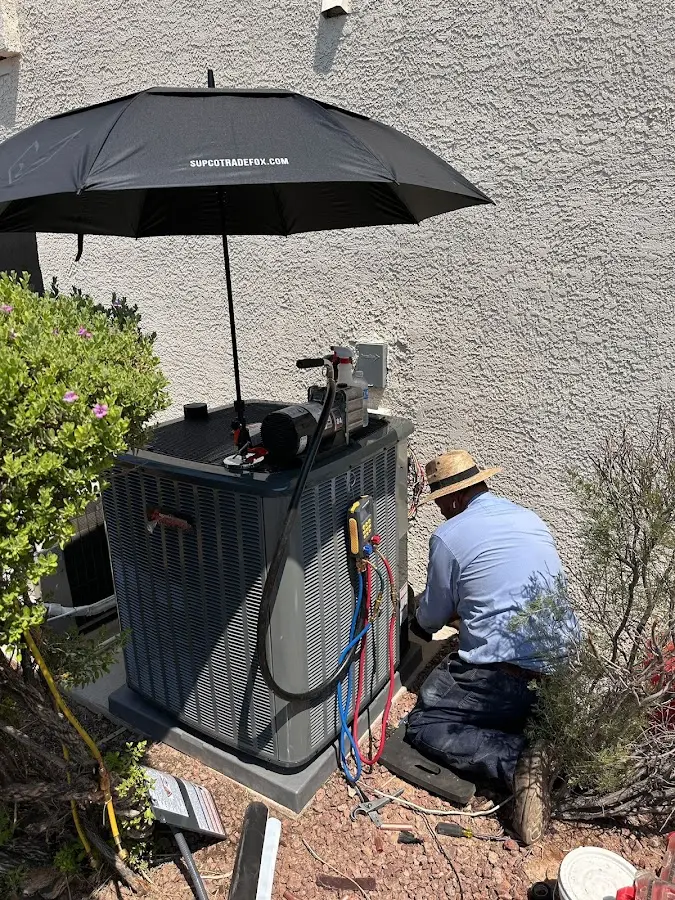 HVAC technician performing outdoor AC maintenance in Georgetown