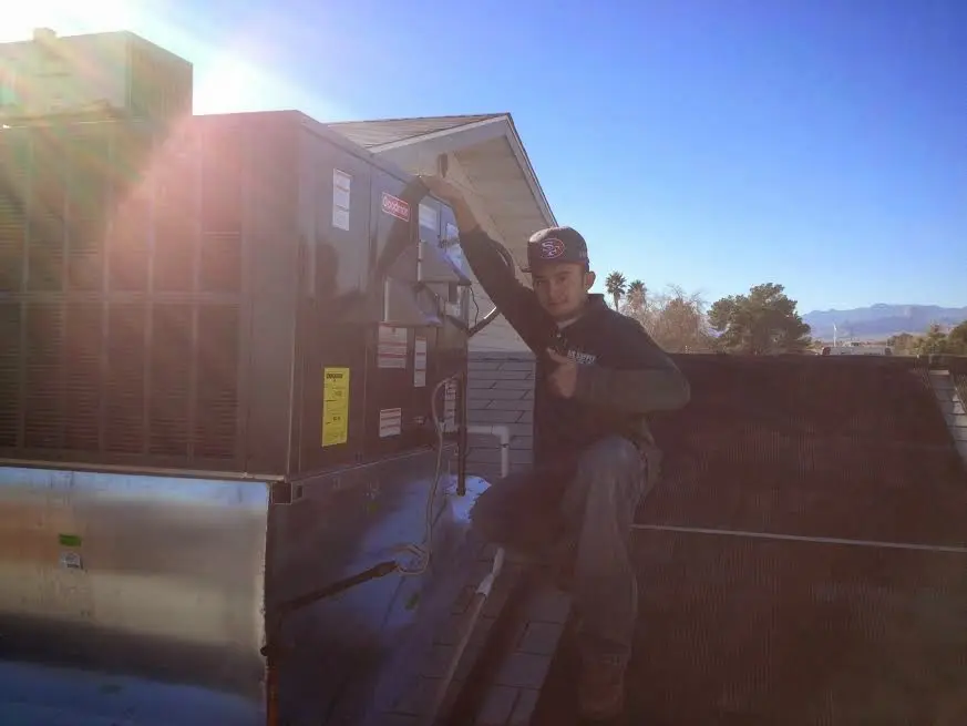 HVAC technician performing Boiler Repair on a rooftop unit in Georgetown